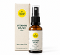 Freundnatur Vitamin D3 + K2 Kids Spray für Kinder, vegane Flasche und Verpackung vor weißem Hintergrund, 30 ml